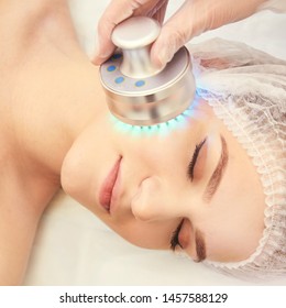 Light Infrared Therapy. Cosmetology Head Procedure. Beauty Woman Face. Cosmetic Salon Device. Facial Skin Rejuvenation.