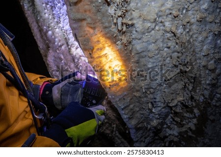 Light inside stalactite from the flashlight in the cave.
