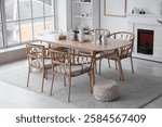 Light interior of room with dining table, fireplace and winter decor