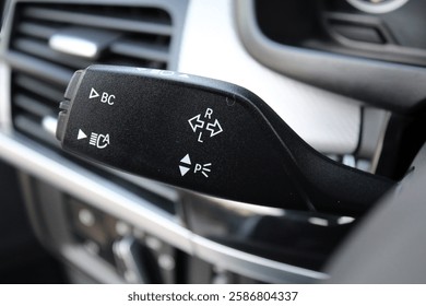 The light knob in the car. Multifunction Headlight Console Control Switch knob. Car interior with light switch. Headlight switch; Turn signal lever; Fog light switch.