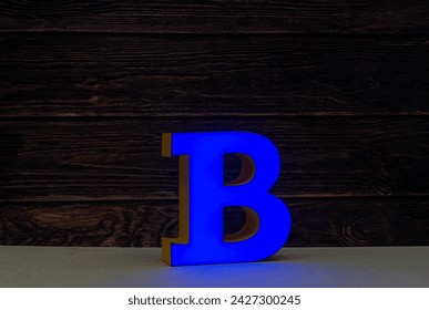The light letter B is part of an advertising sign. Blue color.