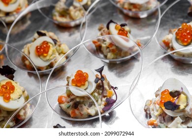 Light Meat Appetizer And Chicken Egg With Red Caviar And Herbs In Transparent Cups On The Table. Restaurant Service.