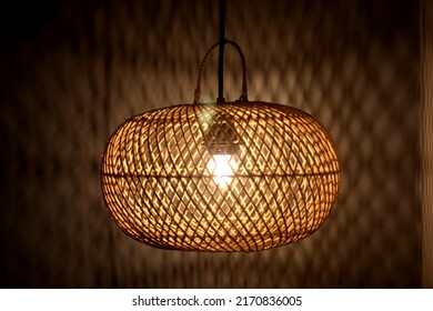 Light Of Modern Hanging Wooden Lamp, Hanging On The Ceiling In The Bedroom At Night. Lamp Shade. Light And Shadow.