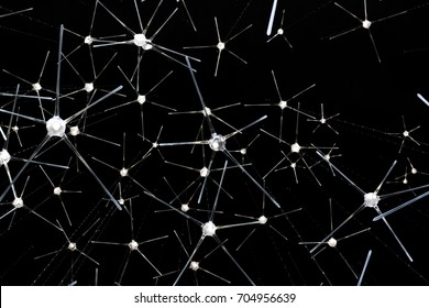Light of modern lamp hanging from the ceiling with black background. Star lamp hanging and dark pattern. Atomic Structure.