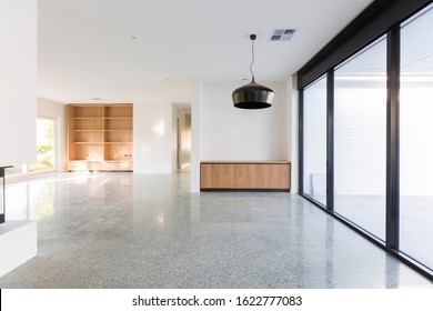 Light And Modern Living Area With Pendant Light And Timber Bookshelf