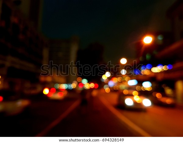 Light night at city blue bokeh abstract background blur\
lens flare reflection beautiful circle glitter lamp street with\
dark sky 