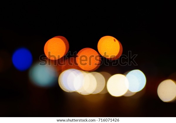 Light night at city blue bokeh abstract\
background blur lens flare reflection beautiful circle glitter lamp\
street with dark sky festival\
firework