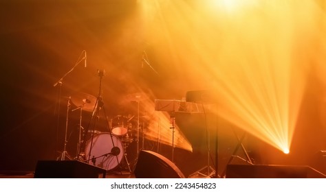 Light on a free music stage, rock group scene with spotlights in fog - Shutterstock ID 2243454823