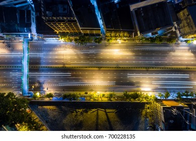 The Light On The Road Roundabout At Night And The City In Bangkok, Thailand. Aerial View. Top View. Background Scenic Road.