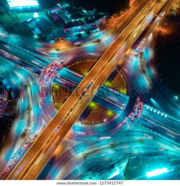 The light on the road roundabout\
at night and the city in Bangkok, Road beautiful Aerial View of\
Busy Intersection, Aerial view. Top view. Background scenic\
road.
