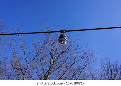 light on the string and wire in the blue sky