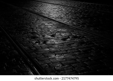 Light on a Wet Cobbled Tramway at Night, Dublin, Ireland in Black and White