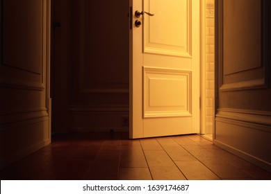 Light From The Open Door To The Dark Corridor Of The Apartment. Interior Empty House With Wooden Floor