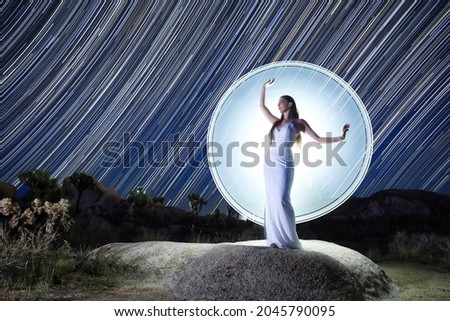 Light Painted Model Posing with Star Trails in Desert Setting