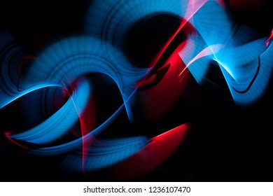 Light painting abstract background. Blue and red light painting photography, long exposure, ripples and swirl against a black background. - Powered by Shutterstock