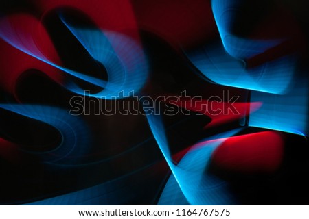 Light painting abstract background. Blue and red light painting photography, long exposure, ripples and swirl against a black background.