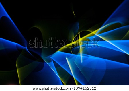 Light painting abstract background. Blue and yellow light painting photography, long exposure, ripples and swirl against a black background. 
