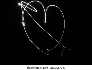 Light Painting Of A Heart With An Arrow.