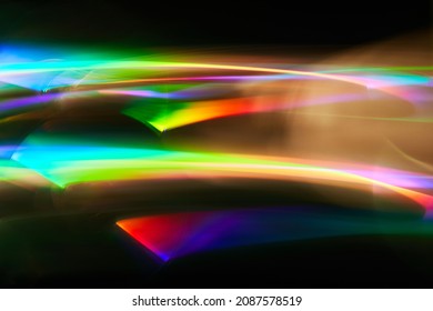 Light Painting One Exposure In Camera. Light Glares With A Spectral Gradient On A Dark Background. Multicolored Abstract Colorful Line.