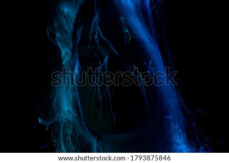 Similar – Beautiful young woman posing with blue makeup