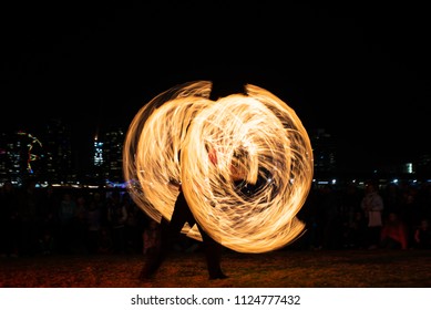 Light painting of a street performer of fire in Firelight festival at Docklands, Melbourne, Australia 