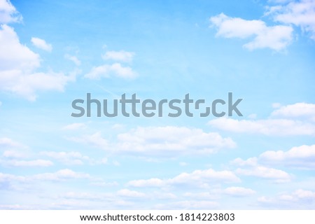 Light pastel blue sky with clouds, may be used as background