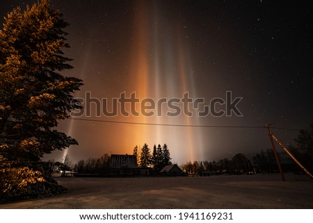 Light Pillars. Rare meteorological phenomena. Winter nature landscape.
