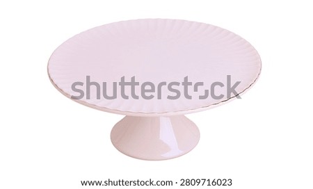 Light pink ceramic cake stand with scalloped edge and pedestal base