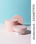 A light pink circle podium against light blue background. An empty platform for display cosmetic products, food and props.