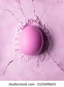 Light Pink Egg On Broken Pastel Background. Creative Monochromatic Food Concept. Minimalistic Easter Composition.