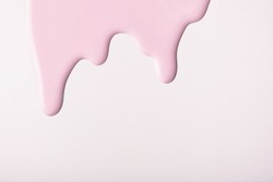 Light Pink Liquid Drops Of Paint Color Flow Down On Isolated White Background. Abstract Pearl Backdrop With Rose Fluid Drip Pattern. Acrylic Painting With Copy Space.