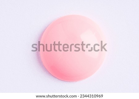 Light pink paint swatch on white paper background. Peach color swatch of lip gloss, cosmetic product stroke gouache, oil paint texture, cosmetic or beauty product texture.	