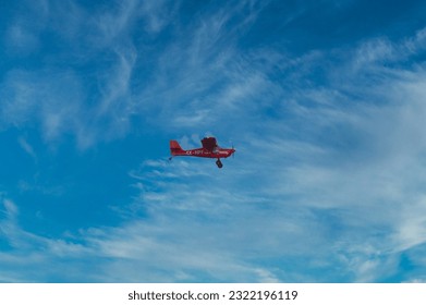A light plane flies in the sky - Shutterstock ID 2322196119