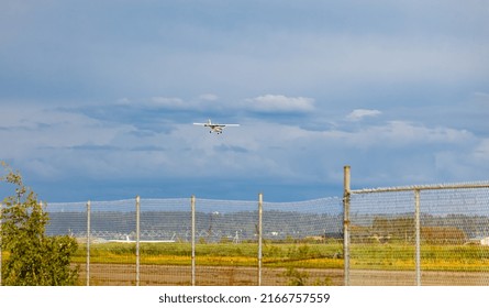 Light Plane Landing On The Runway On The Airfield. Small Airplane In The Sky, Student Is Learning How To Land On The Ground. Travel Photo, Nobody, Copy Space For Text-May 29,2022-Surrey BC, Canada