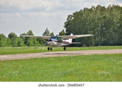 Light Plane Landing On The Runway On The Airfield