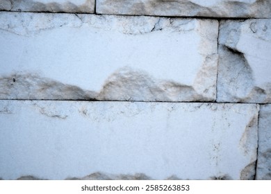 Light plays on the surface of weathered stone, showcasing intricate patterns.
