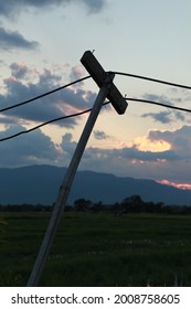 Light Pole Made Of Simple Wood In The Countryside, Tilting, Will Fall, Unstable Causing Insecurity.