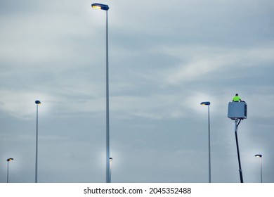 Light Pole Repairing. Worker In Lift Bucket Installing New Lights. Modernization Of Street Lamps