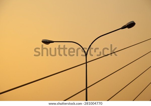 Light pole and rope bridge During the evening,\
the sun turns orange.