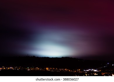 Light Pollution From Sports Fields. A Rainy Night Shows Light From University Pitches At Night, Above The City Of Bath, UK