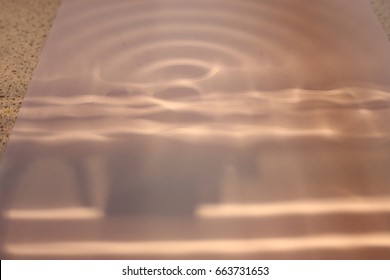 The Light Projections Of A Ripple Tank On A Piece Of Paper.