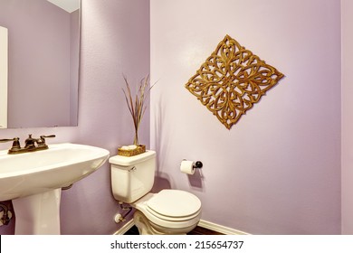 Light purple bathroom decorated with handcrafted art