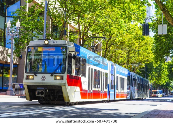 Light rail car image taken in Portland, Oregon, USA\
on July 25th, 2017. Commuters and tourists take this street car\
around the city