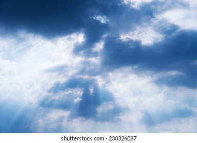 Light rays shine through the  clouds