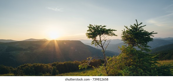 Light Rays Streaming through Clouds over Mountain Range