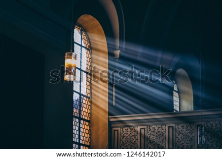 Light rays through the dark window. Toned photo
