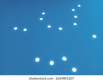 Light Reflection Patterns, Abstract image showing bright circular light reflections on blue and gray background.