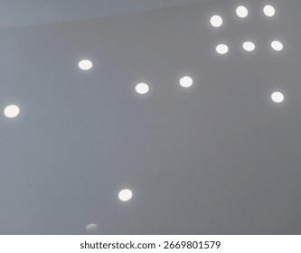 Light Reflection Patterns, Abstract image showing bright circular light reflections on blue and gray background.