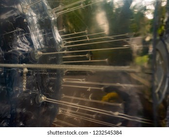 Light And Reflections As Seen Through A Giant Plastic Ball With Suspension Cords. Like A Blue Planet.