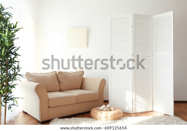 Light room interior\
with folding screen